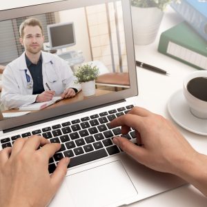 Doctor with a stethoscope. Telemedicine concept Doctor with a stethoscope on the computer laptop screen. Telemedicine or telehealth concept.